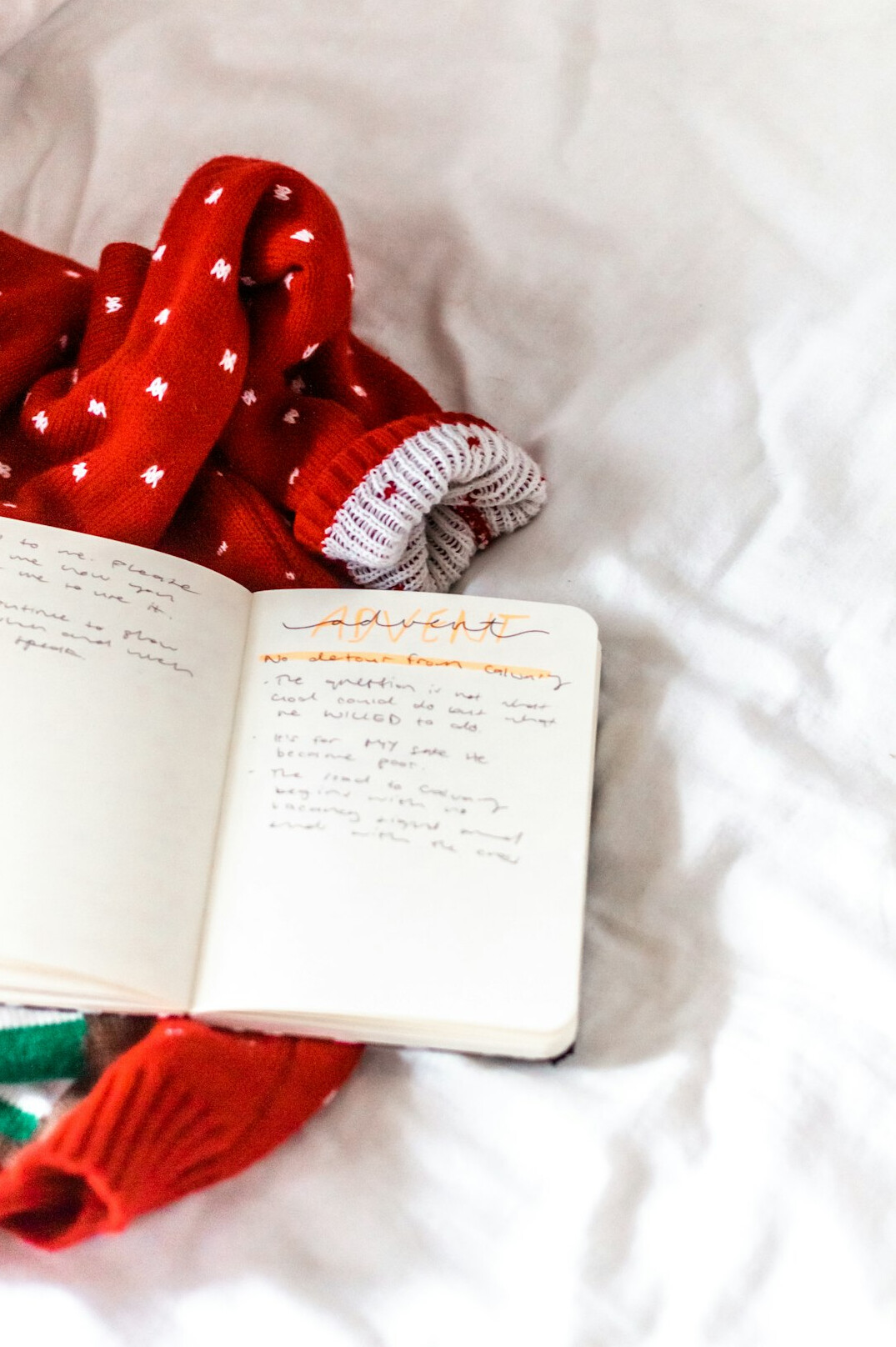 Open notebook with handwritten notes and a pen